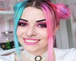 Moa has piercing in her nose septum and lower lip.